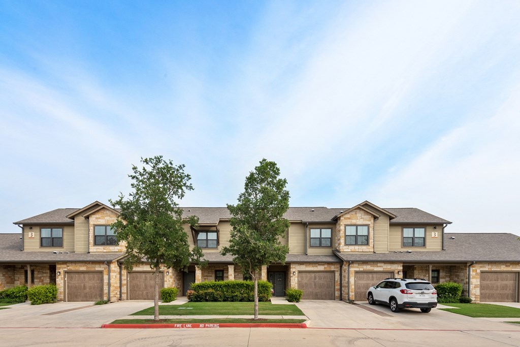 an apartment building with a car parked in front of it