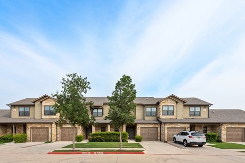 an apartment building with a car parked in front of it