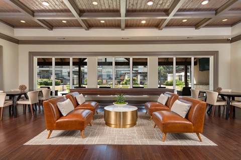 a lounge area with leather chairs and a coffee table
