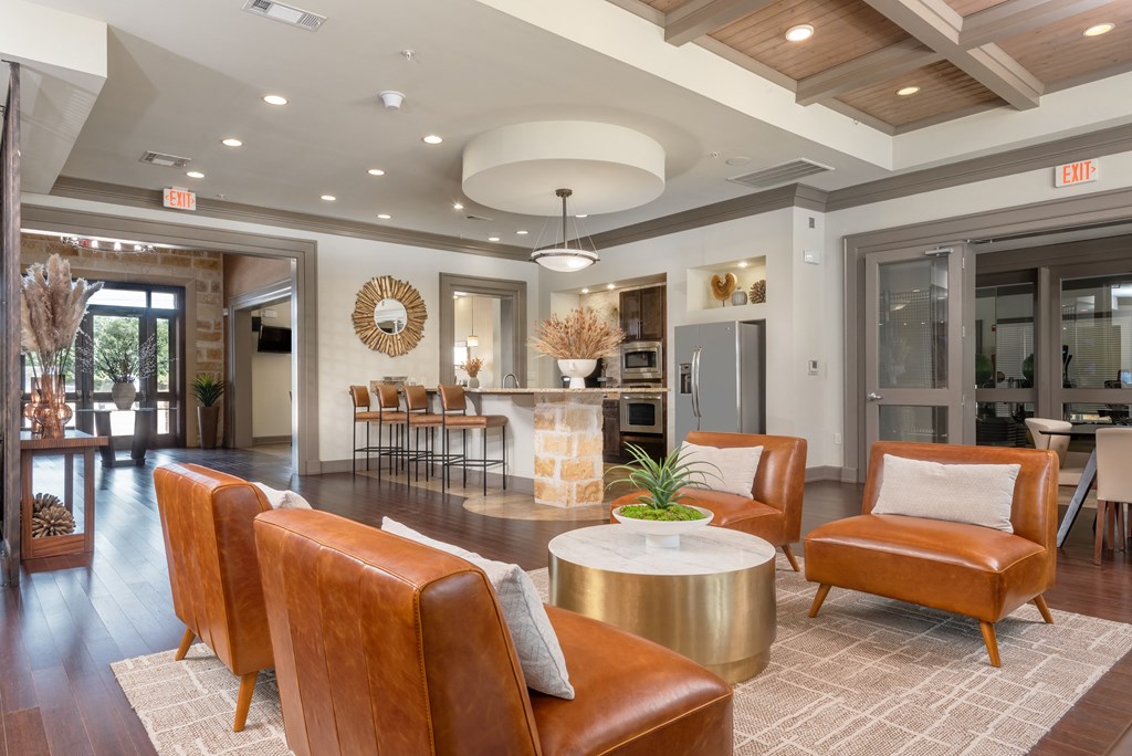 a living room with leather chairs and a fireplace