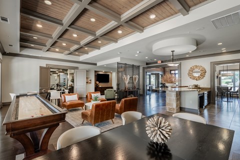 a large room with a table and chairs and a pool table