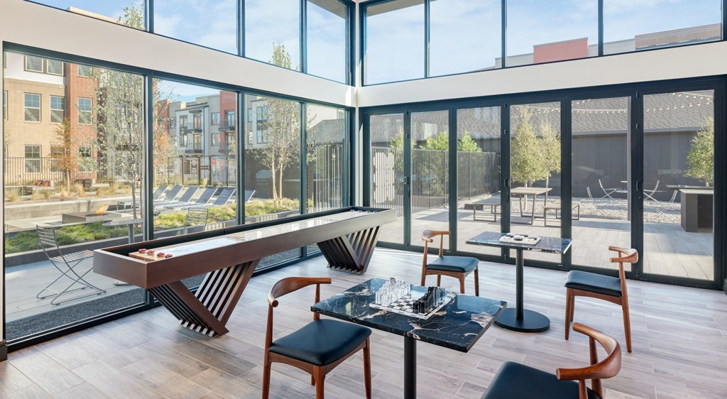 A modern dining room with a glass table and chairs.