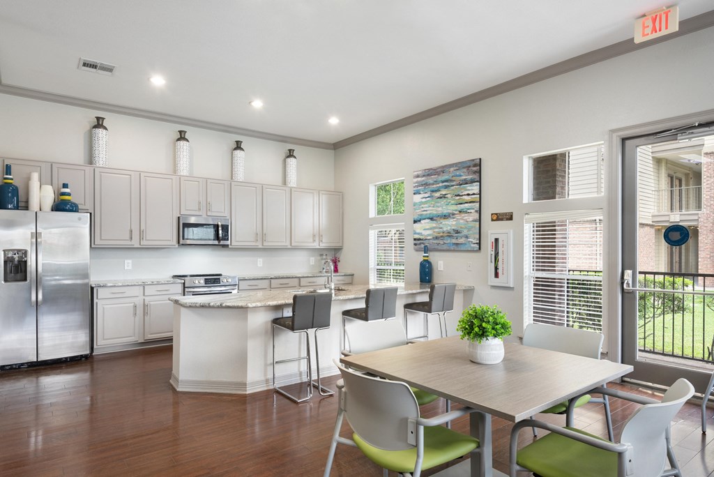 an open kitchen and dining room with a table and chairs