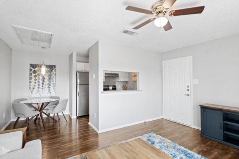A kitchen with a table and chairs.