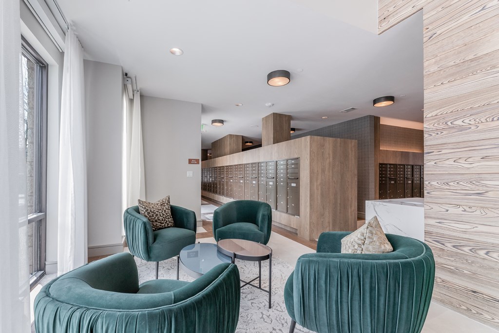 a living room with two blue chairs and a glass table