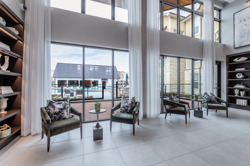 a living room with large windows and a view of a swimming pool