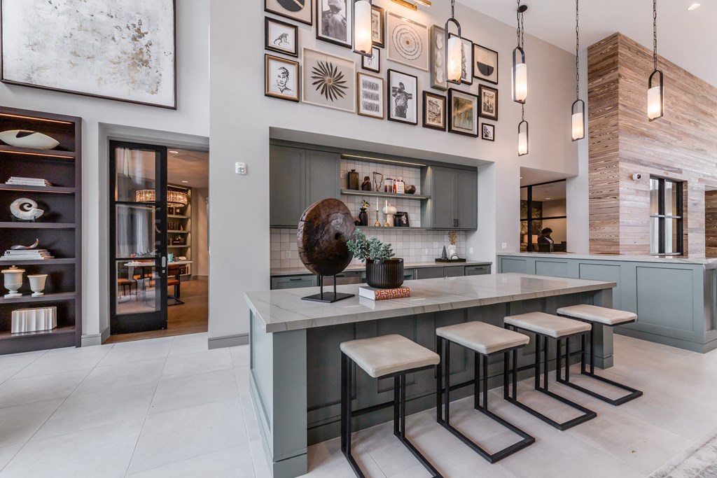 a kitchen with a marble counter top and stools