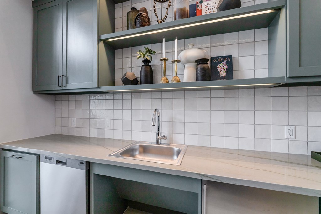 a small kitchen with a sink and cabinets