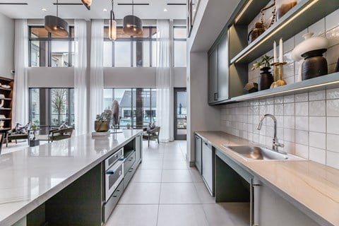 a large kitchen with a large window and a sink and counters