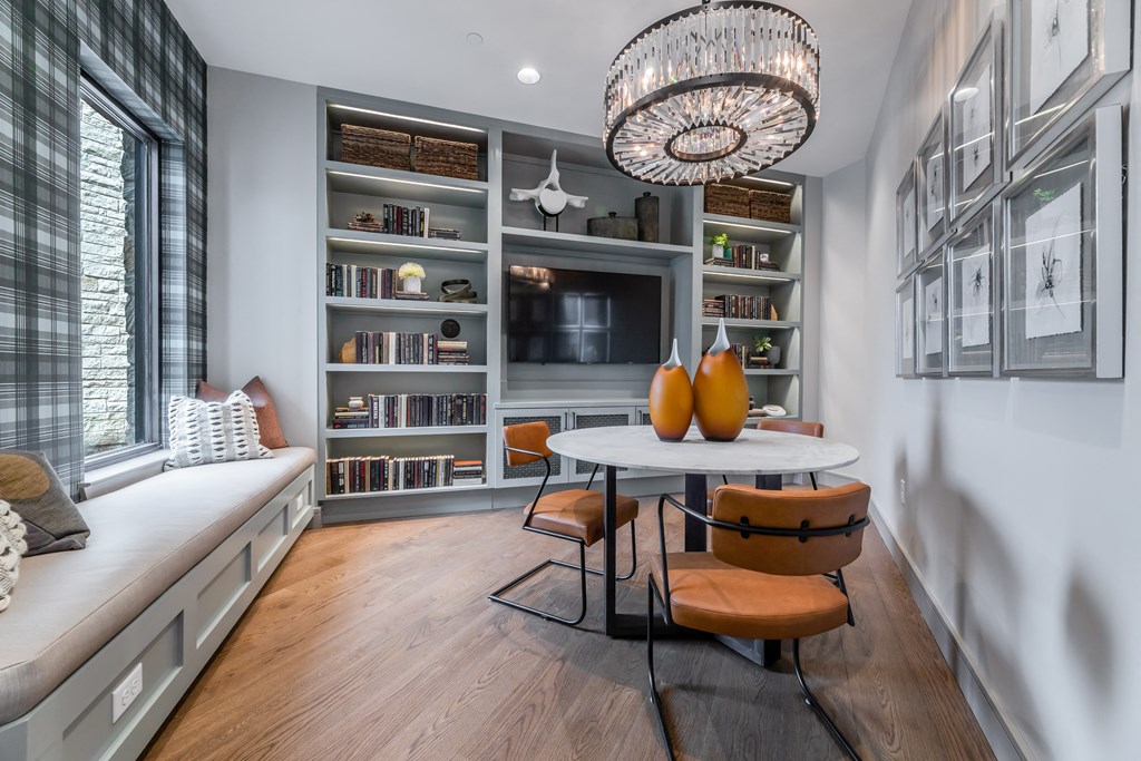 a living room with a table and chairs and a television