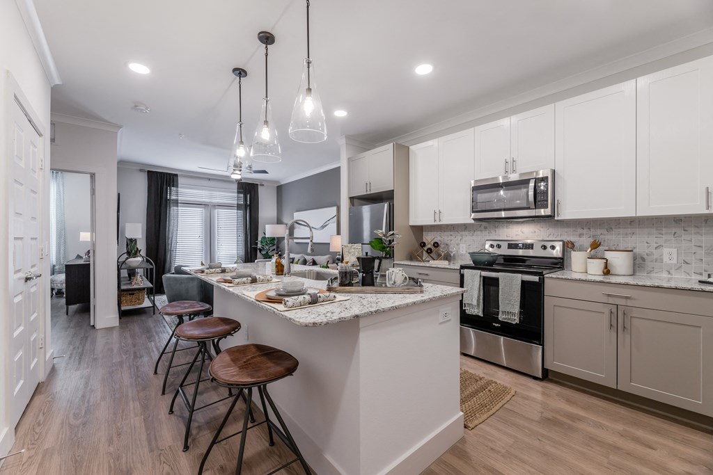 an open kitchen and dining area with a large island and stools
