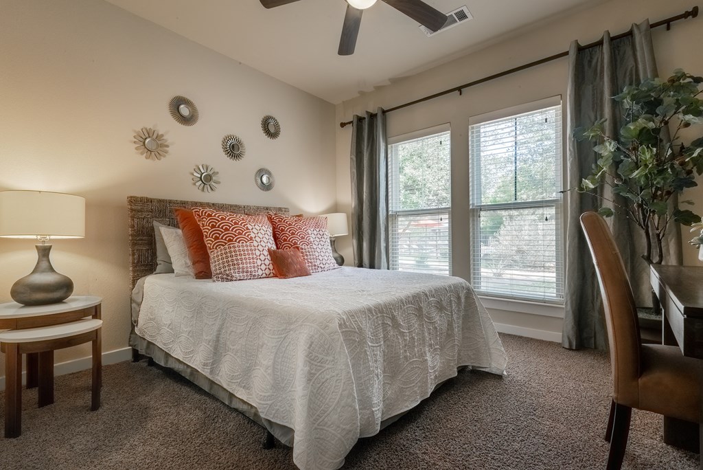 a bedroom with a bed and a desk with a chair