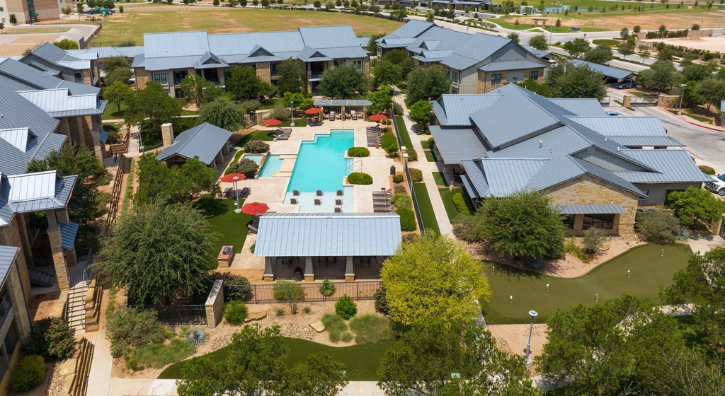 an aerial view of a house with a swimming pool in the backyard