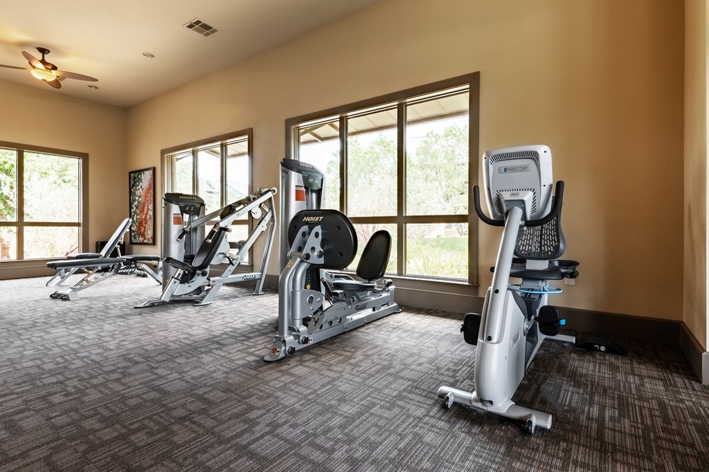 a gym with treadmills and other exercise equipment