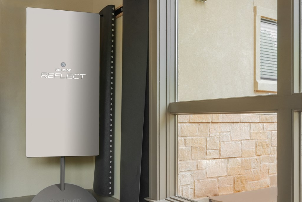 a room with a window and a table with a lamp