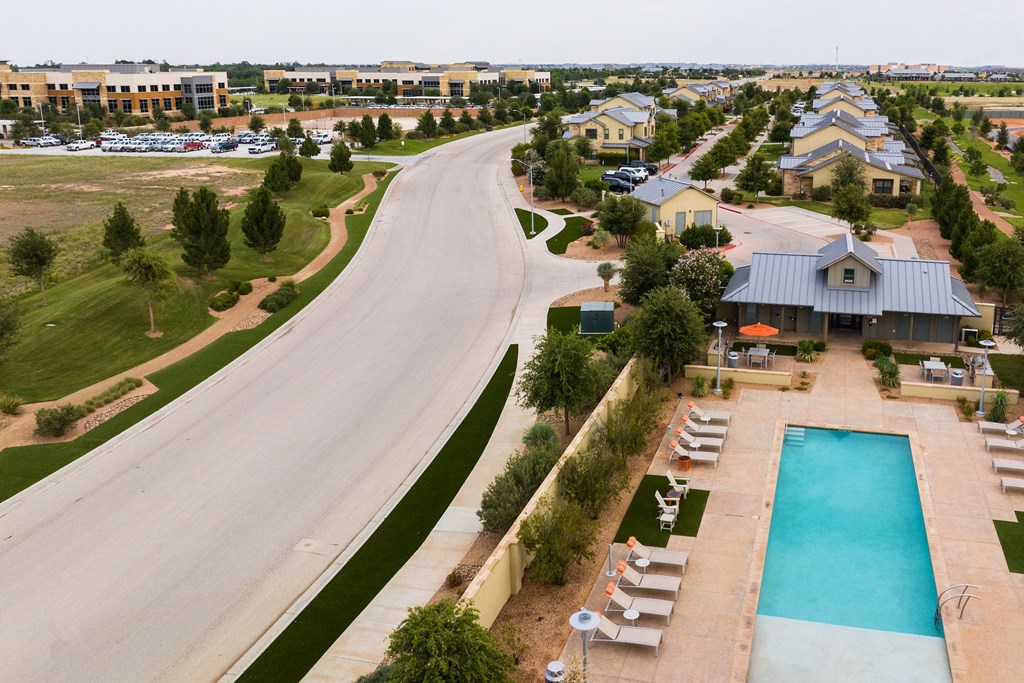 an aerial view of a house with a swimming pool in front of it