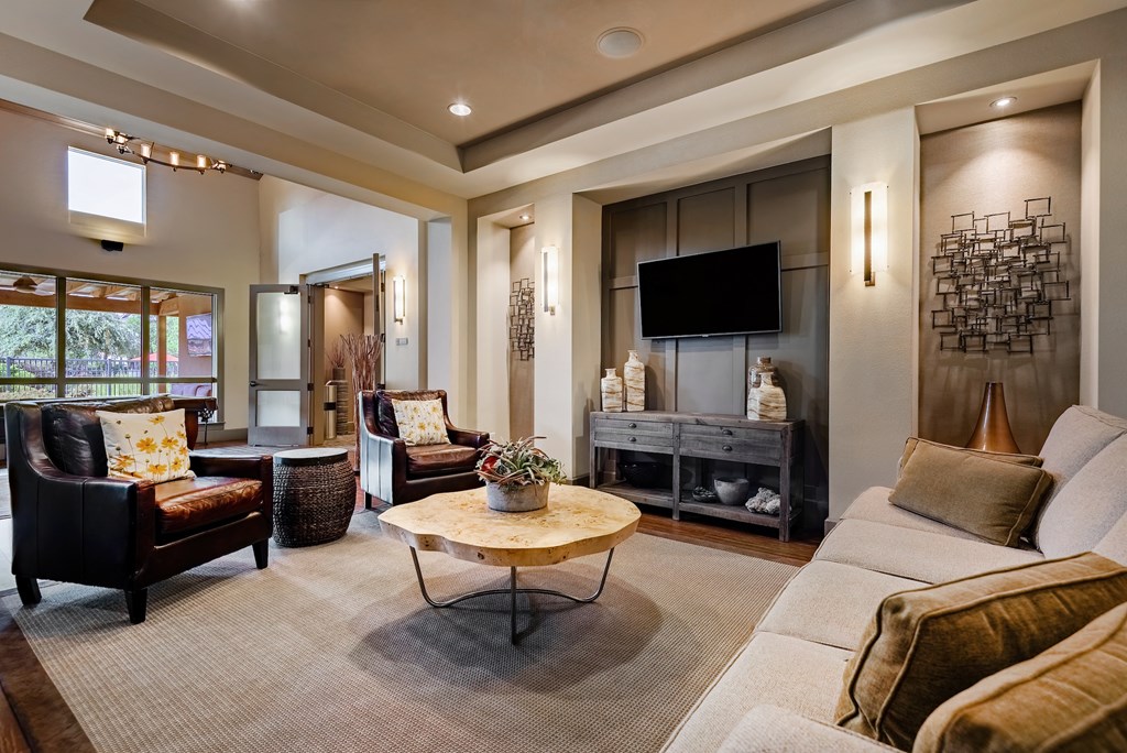 a living room filled with furniture and a flat screen tv