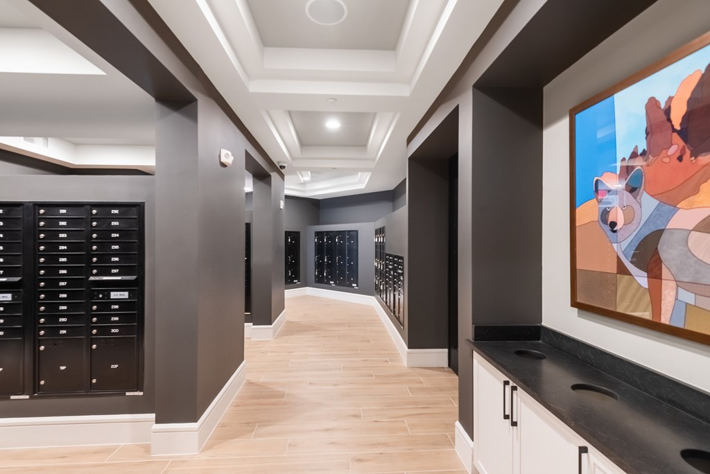 A hallway with a large painting of a bear on the wall.