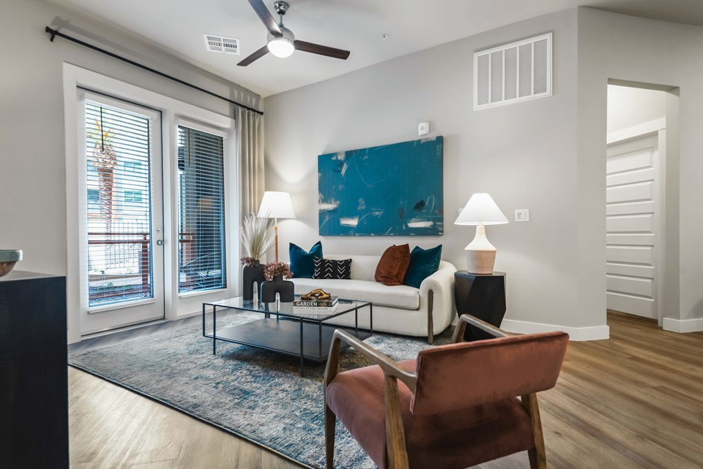 A living room with a brown chair and a blue rug.