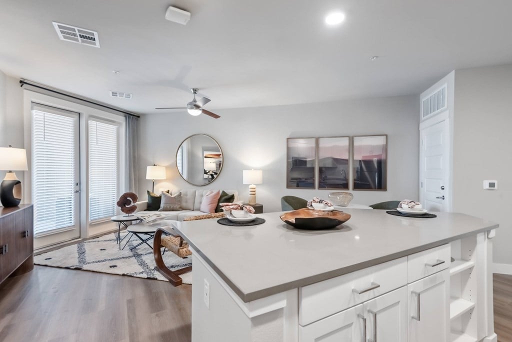 A modern kitchen with a large island and a dining area.