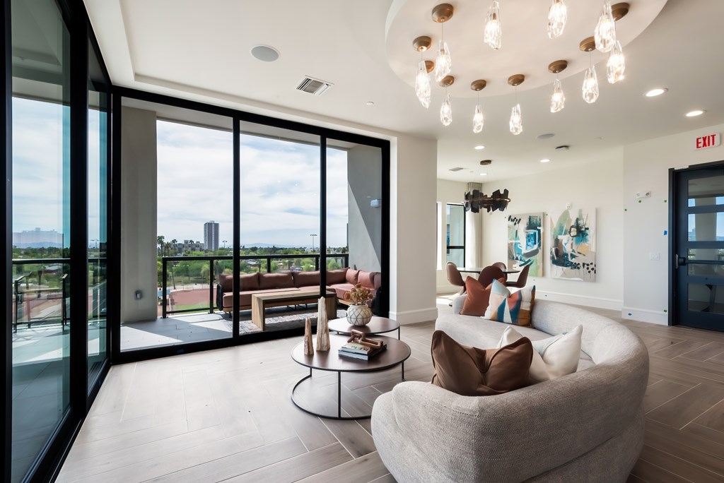 A modern living room with a large window overlooking the city.
