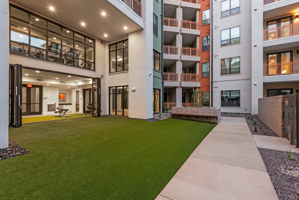 A modern building with a green lawn in front.
