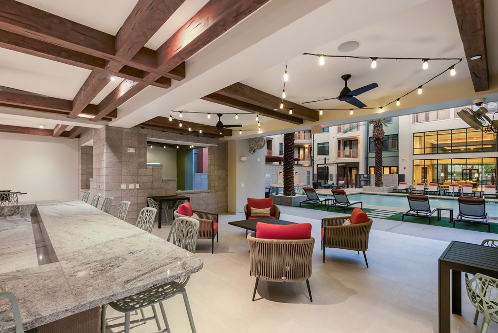 A large room with a pool table and chairs.
