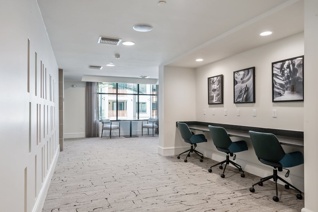 A conference room with a long table and chairs.