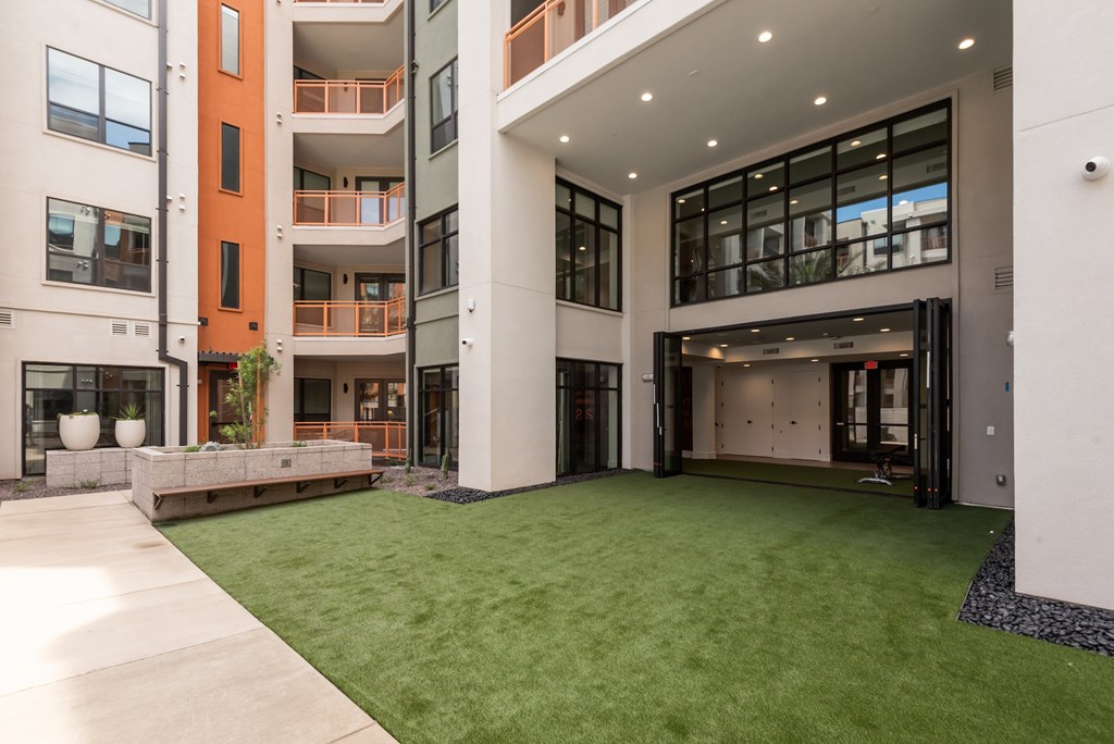 A modern building with a green lawn in front.