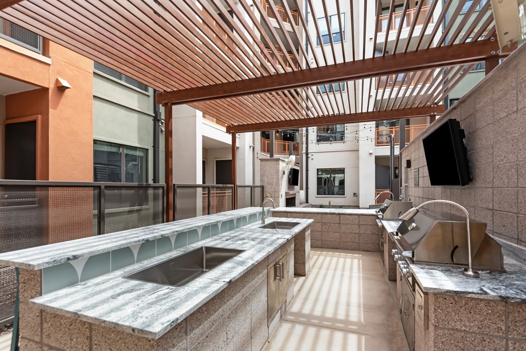 A kitchen with a wooden ceiling and a counter top.