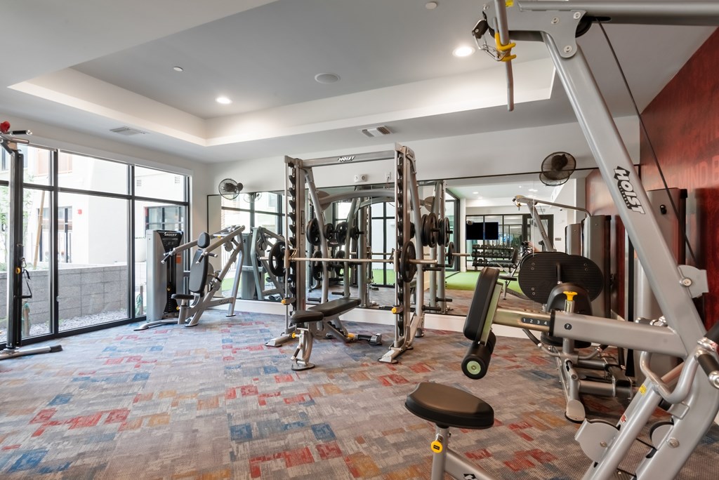 A gym with a variety of equipment including a leg press machine.