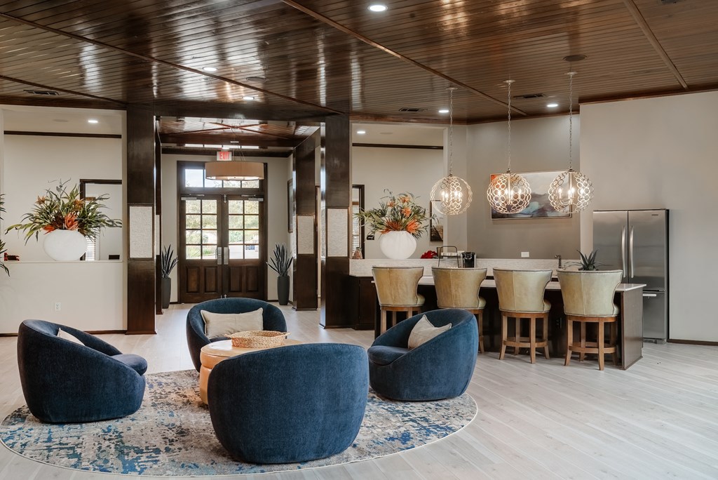 a living room and dining room with blue chairs and a kitchen