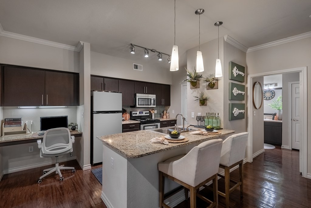 an open kitchen and dining area with a granite counter top