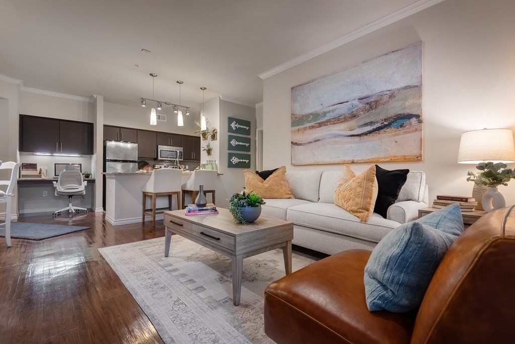 a living room and kitchen with a couch and a coffee table