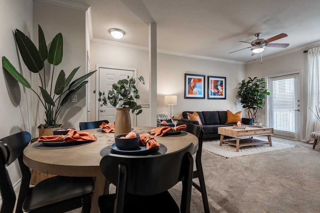 an open living room and dining room with a table and chairs