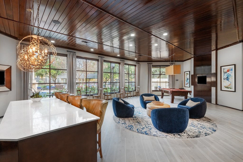 a living room with couches and chairs and a table