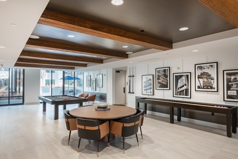 A modern dining room with a round table and chairs.