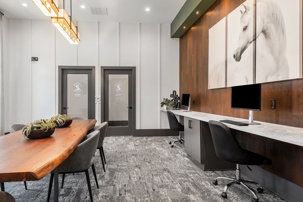 a conference room with a desk and a table with chairs