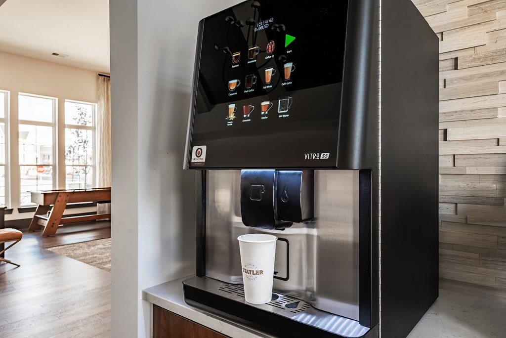 a coffee maker and a cup on a counter in a living room