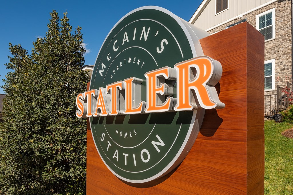 a sign for a statler station station with a clock on it