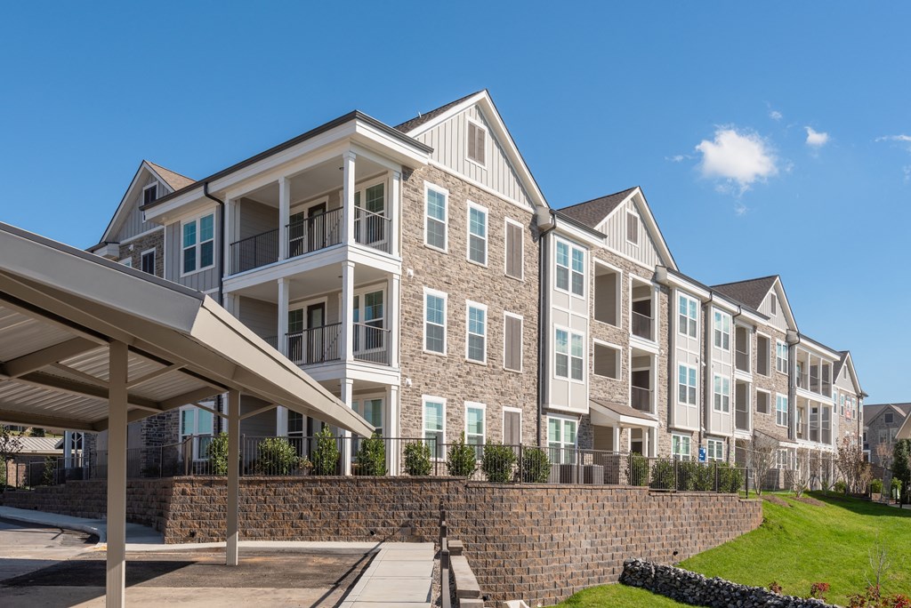 a row of apartment buildings with a sidewalk in front of them