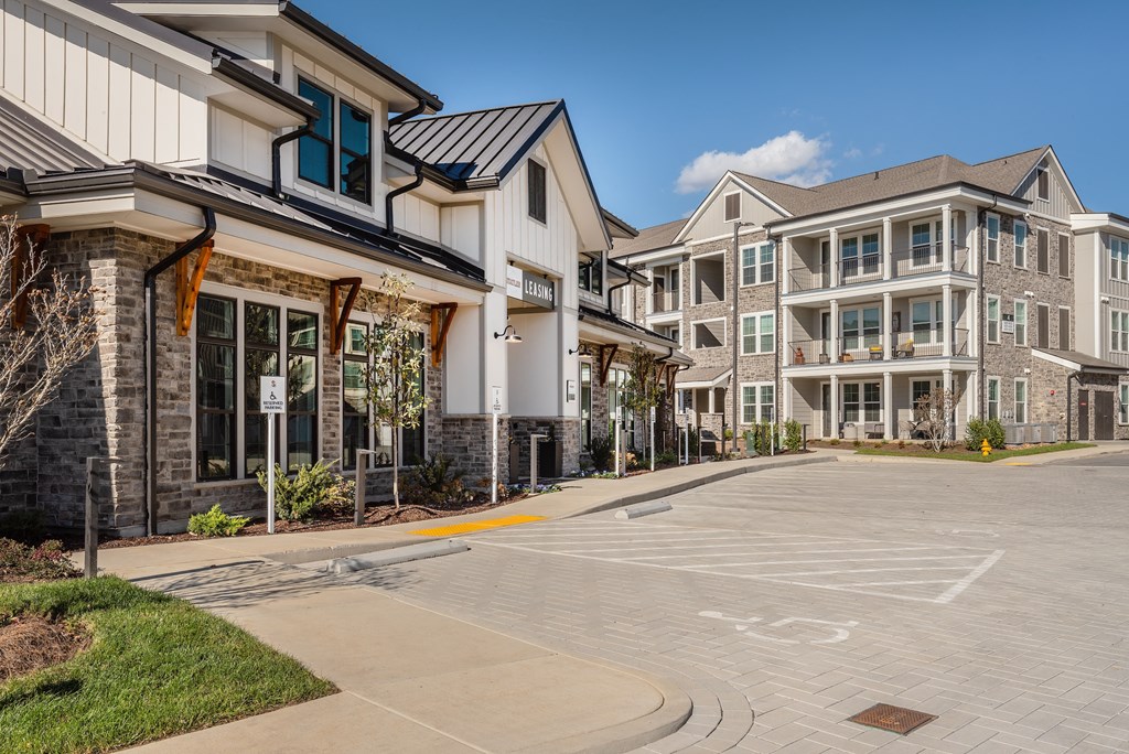 an empty street in front of a row of apartment buildings