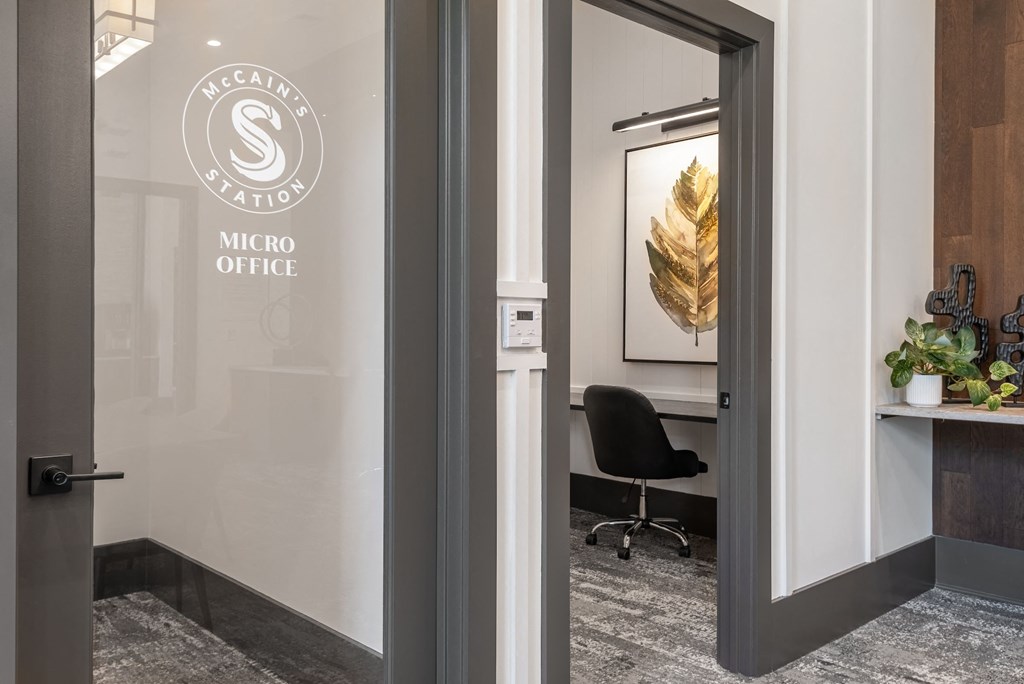 the entrance to a metro office with a chair and a desk