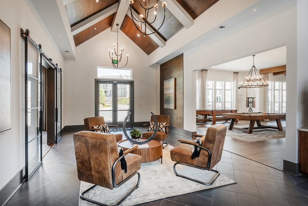 a living room with chairs and a table