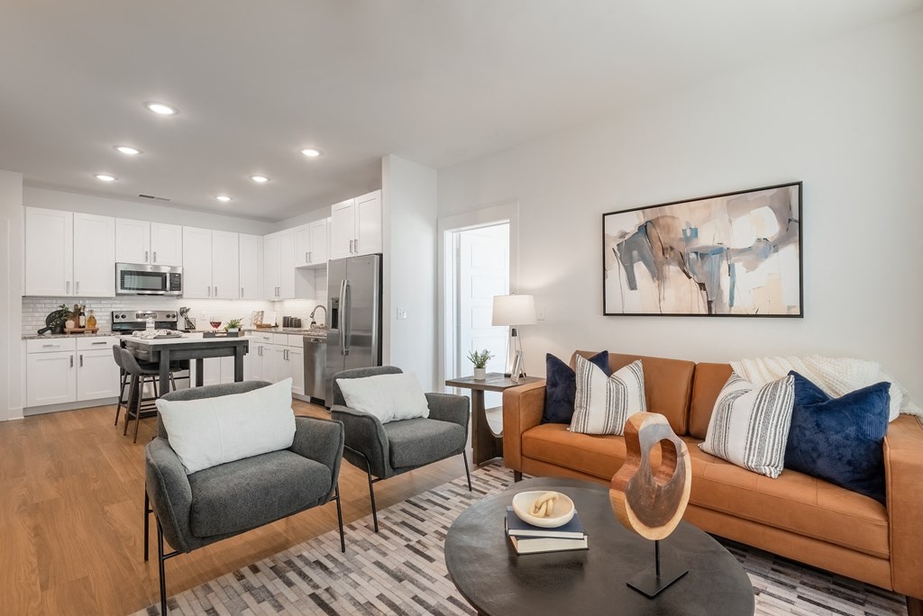 a living room with a couch and chairs and a table