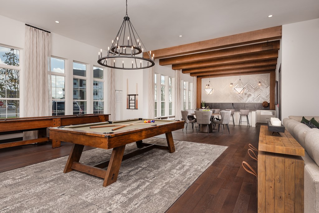 a large living room with a pool table and a dining room