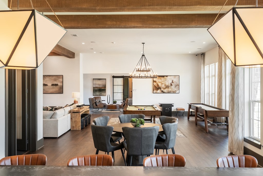 a dining room and living room with a table and chairs