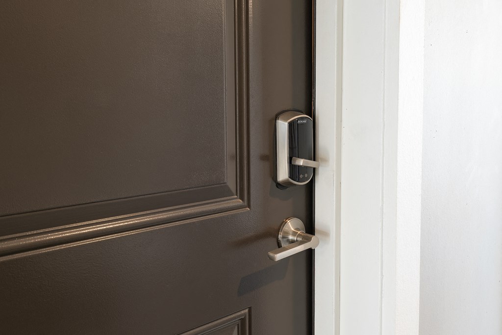 a door with a silver door handle and a white door frame