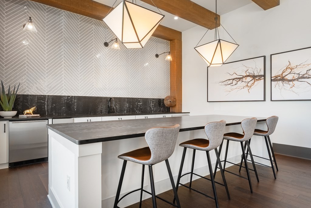 a kitchen with a marble counter top and bar stools