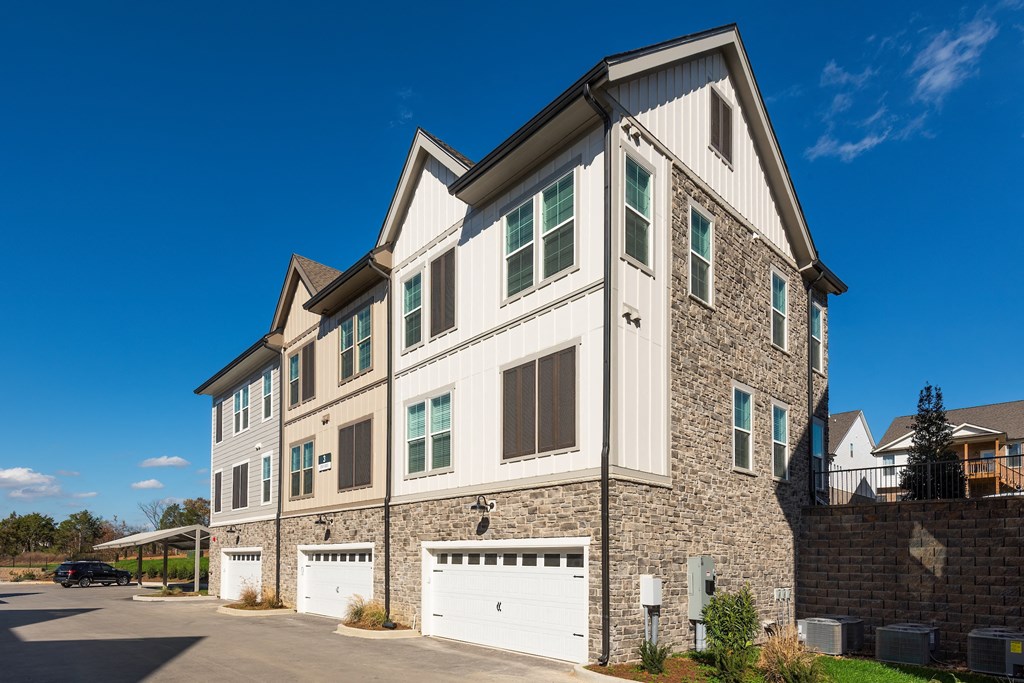 a large house with a white garage door in front of it